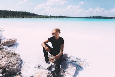 Full length of boy on beach against sky