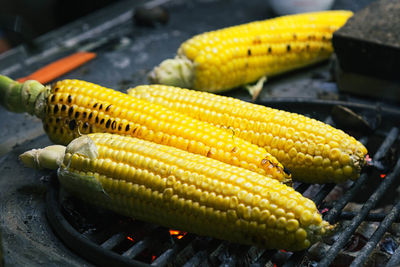 Close-up of corns on barbeque at street market