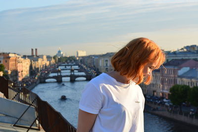 Redhead woman against sky