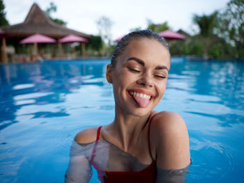 Portrait of smiling young woman in swimming pool