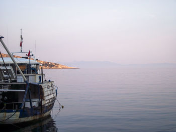 Ship moored in sea against sky