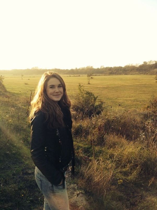 field, lifestyles, leisure activity, grass, landscape, young adult, casual clothing, clear sky, standing, young women, long hair, person, tranquility, grassy, rural scene, looking at camera, tranquil scene, nature