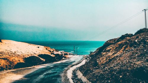 Panoramic view of road by sea against clear sky