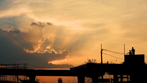 Low angle view of silhouette building against sky during sunset