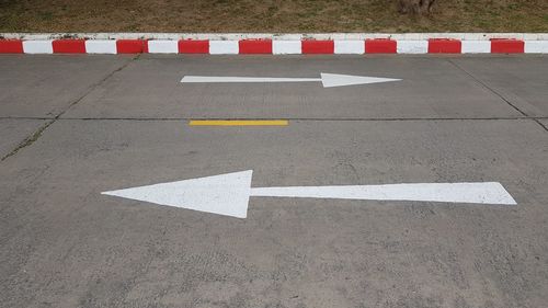 High angle view of arrow sign on road