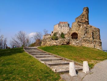 Castle on grass against sky