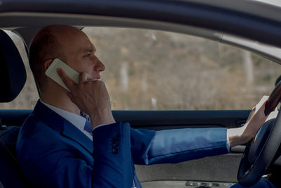Midsection of man sitting in car