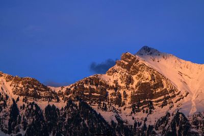 Scenic view of mountains against blue sky