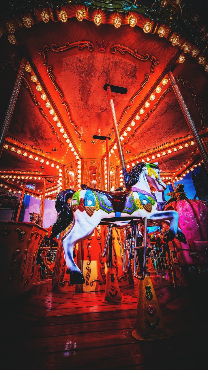arts culture and entertainment, multi colored, stage, illuminated, architecture, person, night, performance, lighting equipment, amusement park, indoors, musical theatre