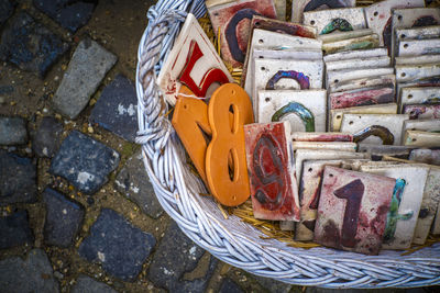 High angle view of multi colored candies in basket on footpath