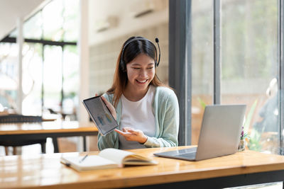 Businesswoman using laptop at office
