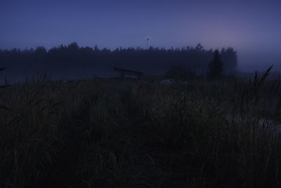 Scenic view of field against clear sky at night