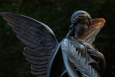 Low angle view of angel statue at graveyard