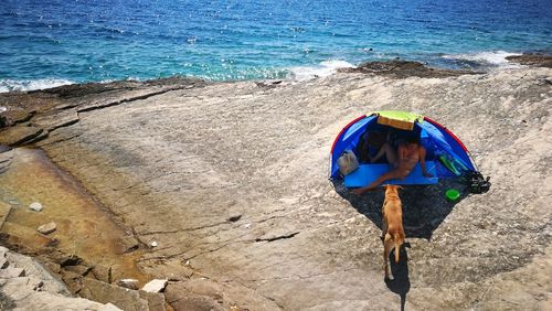 Woman with umbrella on beach