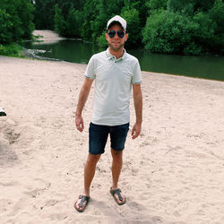 Full length of young man standing at beach