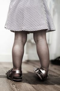 Low section of baby girl standing on floor