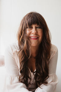 Portrait of smiling young woman sitting at home