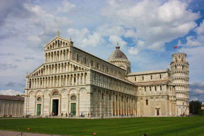 Cathedral of the pisa tower on the grass of piazza dei miracoli in tuscany