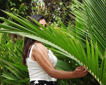 Midsection of woman standing by plants
