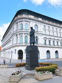 Low angle view of statue against historic building