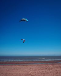 Scenic view of beach against blue sky