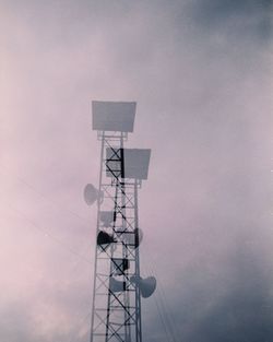 Low angle view of communications tower against sky