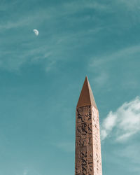 Low angle view of statue against blue sky