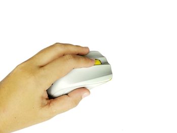 Close-up of hand holding paper over white background