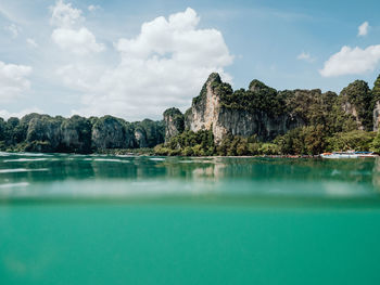 Scenic view of rock formation in sea against sky