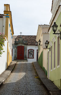 Alley amidst buildings against sky