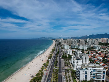 Scenic view of sea by city against sky