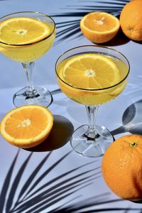 High angle view of oranges on table with drinks 