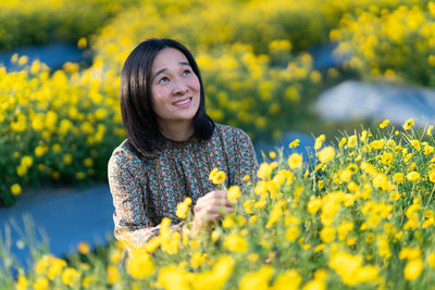 Portrait of a smiling young woman on field