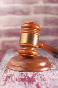 Close-up of gavel  on table