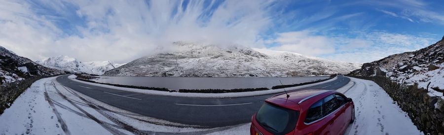 Panoramic shot of snow covered mountains against sky