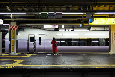 Man standing at railroad station