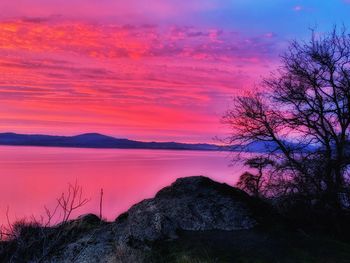 Scenic view of sea against romantic sky at sunset