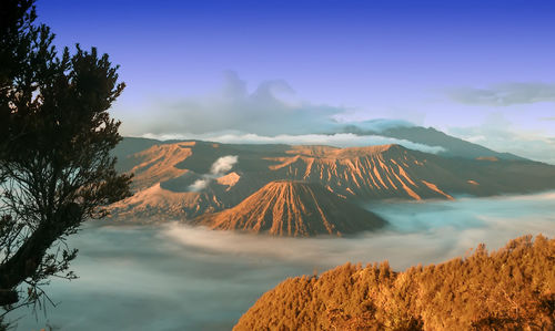 Panoramic view of volcanic landscape against cloudy sky