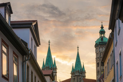 Low angle view of buildings against sky at sunset