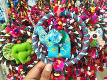 Close-up of hand holding multi colored toys