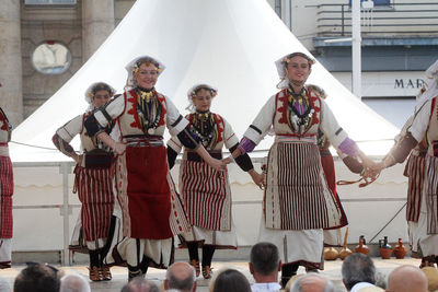 Smiling traditional dancers performing on stage