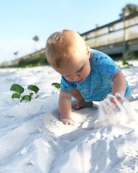 Cute boy playing on sand