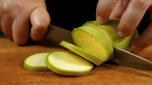 Cropped hand of man holding fruit