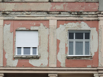 Two windows on the peeled off wall