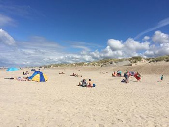People on beach against sky