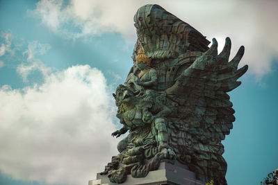 Low angle view of angel statue against sky