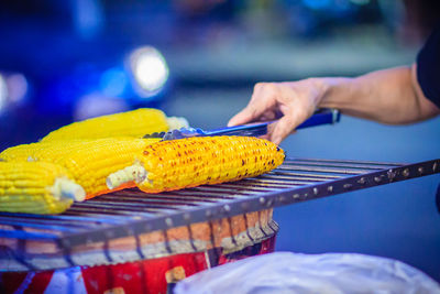 Close-up of hand holding food on table