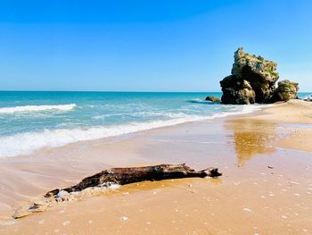 Scenic view of sea against clear blue sky