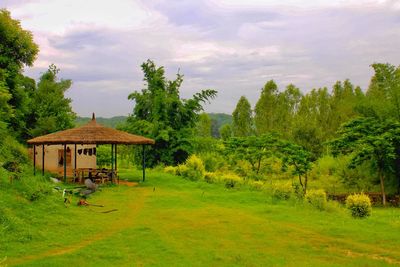 Built structure on field against sky