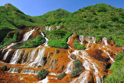 Panoramic view of waterfall against sky